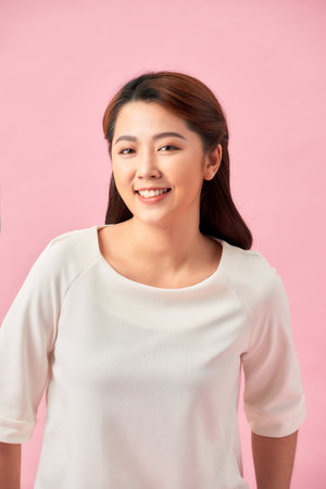 Casual young woman smiling - isolated over a pink backgroundの写真素材