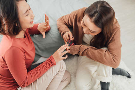 Beautiful Young Girl Does Manicure to Friendの写真素材