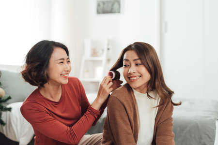 Smiling Two Asian young lovely couple sitting on white bed and happy.の写真素材