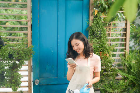A young woman gardening in the gardenの写真素材