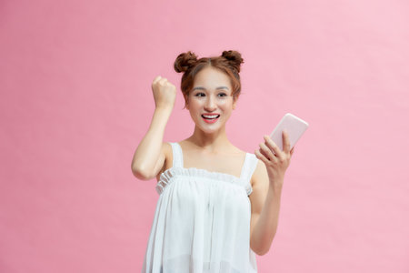 Successful woman is raising fist to celebrate a victory, winner concept.の写真素材