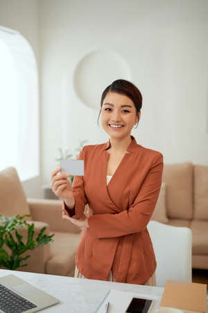 Business woman show white blank card in the office.の写真素材