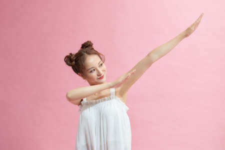 young woman teen smile standing move showing DAB dance against gesture isolatedの写真素材