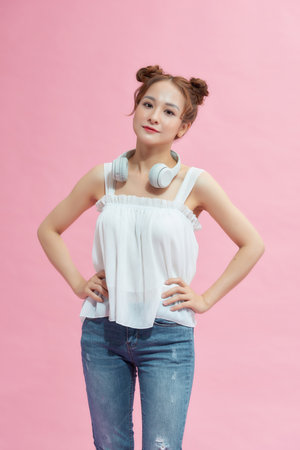 Portrait attractive young asian woman with arms akimbo on waistの写真素材