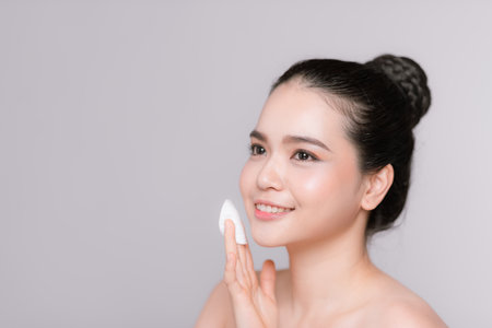 beautiful young asian woman using cotton padsの写真素材
