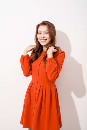 Portrait of a smiling pretty woman looking at camera isolated on a white backgroundの写真素材