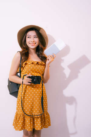 Beautiful travel woman with passport isolated on pastel backgrounの写真素材