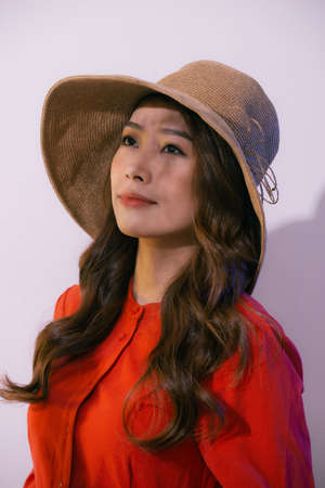 Young woman in hat posing in front of cameraの写真素材
