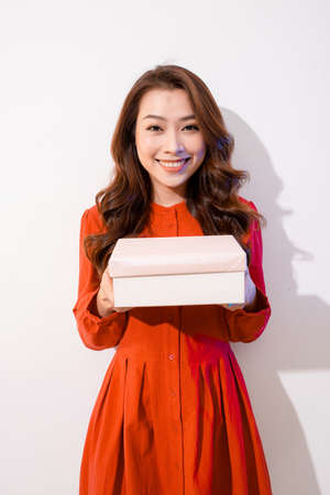 Portrait of beautiful Asian woman holding gift box,の写真素材