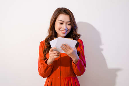 smiling beautiful young woman holding a valentine's day postcard with red heart , valentines day , isolated on white backgroundの写真素材
