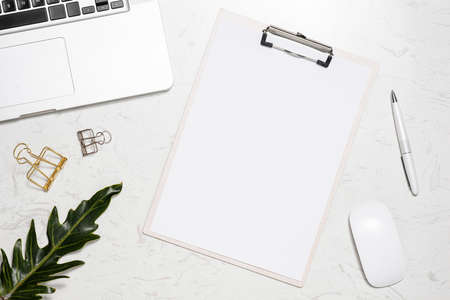 Wooden clipboard mockup wtih workspace accessories on a white table.の写真素材