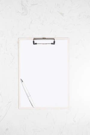 Top view accessories office concept, clipboard and pen on marble table
