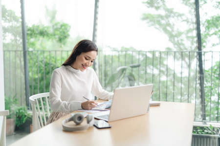 Successful business woman working at the laptop in the officeの写真素材