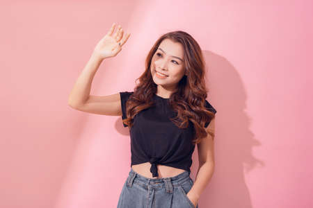 Beautiful Asian young woman hand up cover face protect sun light and UV smile and cheerfulの写真素材