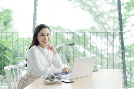 Successful business woman working at the laptop in the officeの写真素材