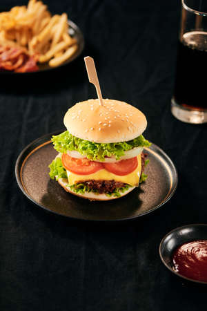 Unhealthy concept. unhealthy food: Burger, sauce, potatoes, cola.の写真素材