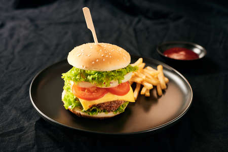 Unhealthy concept. unhealthy food: Burger, sauce, potatoes, cola.の写真素材