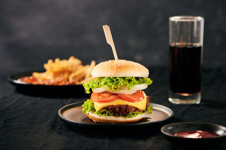 Unhealthy concept. unhealthy food: Burger, sauce, potatoes, cola.の写真素材