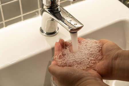 Washing hands rubbing with soap man for winter flu virus prevention, hygiene to stop spreading...