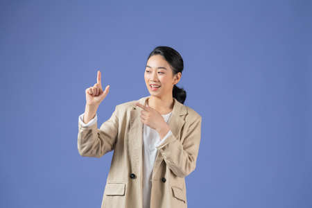 Asian girl holding something invisible in her hands, isolatedの写真素材