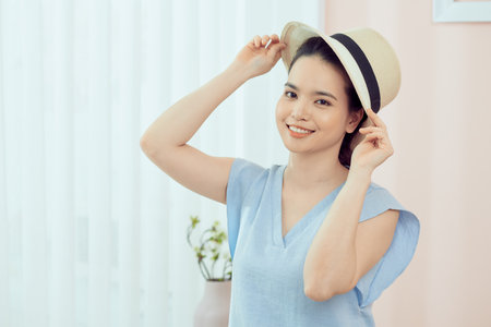 Cheerful young asian woman packing suitcase, getting ready for vacation at home,の写真素材