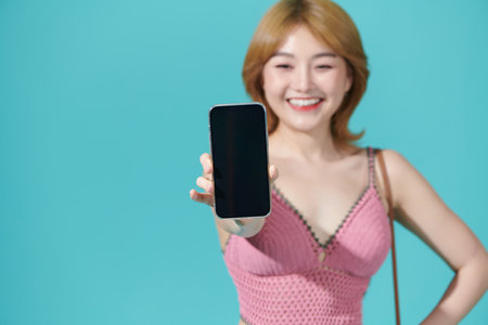 Asian Woman Show Mobile Phone Screen with Blank Copy Spaceの写真素材