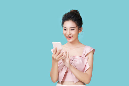 Image of young female using mobile phoneの写真素材