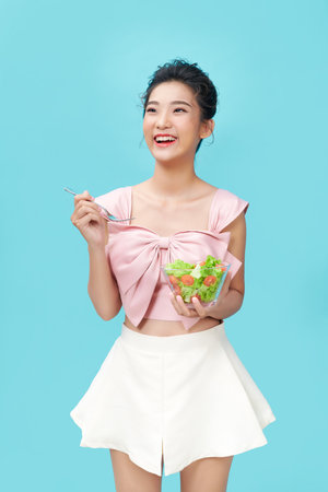 Healthy lifestyles, Asian women holding a salad bowl of fresh vegetables, Good and healthy organic food.の写真素材