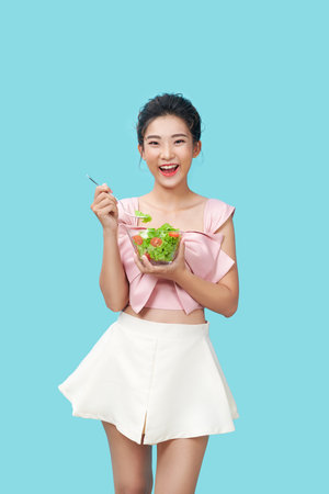 Healthy lifestyles, Asian women holding a salad bowl of fresh vegetables, Good and healthy organic food.の写真素材