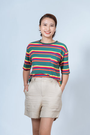 Stylish happy young asian woman with perfect make up, healthy skin smiling, posing on backgroundの写真素材