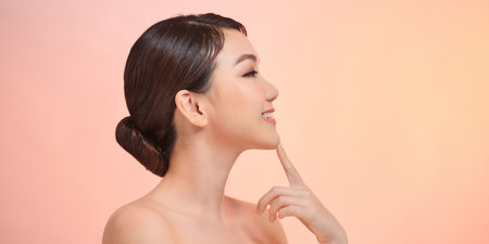 Woman face profile side view. Chin lift pointing with index fingerの写真素材