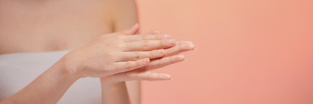 Woman putting cream on hands. Copy spaceの写真素材