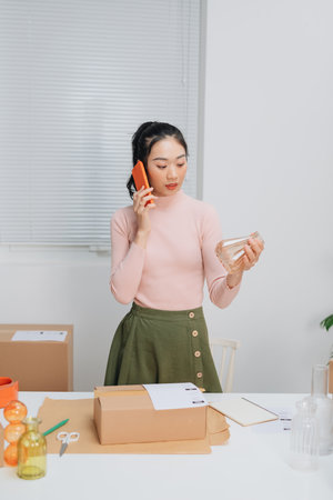 Female online store preparing an order for shipping in a warehouseの写真素材