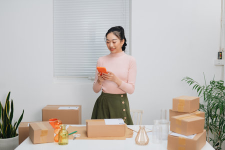 Online store owner preparing an order for shipping in a warehouse.の写真素材