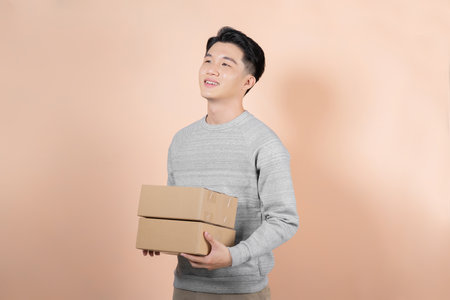 Young Man Holding Card boxes, Indoorsの写真素材
