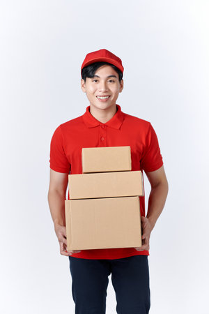 Male employee in cap t-shirt print working as courier dealer hold empty cardboard boxの写真素材