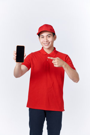 Asian man in a red uniform was pointing at the cell phone in his handの写真素材