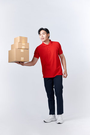 Delivery man with cardboard boxes on white backgroundの写真素材
