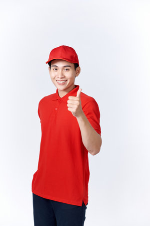 Smiling asian male courier showing thumb up gesture.の写真素材