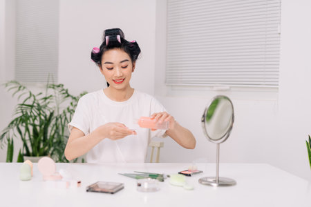 young woman applying facial wipe on her face remover washing makeup, essence or lotion of skin care treatmentの写真素材