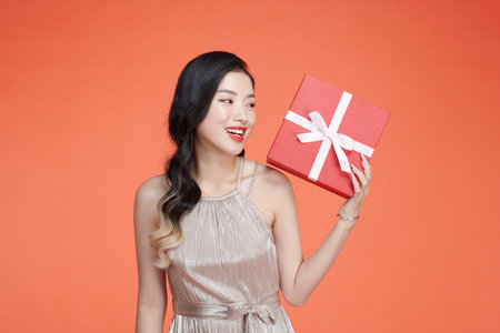 Jolly woman gift decoration joy studio isolated backgroundの写真素材
