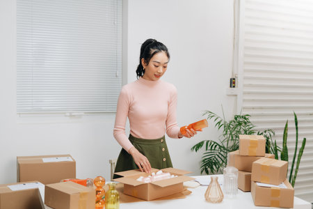 Asian young woman sell vases entrepreneur working at home.の写真素材