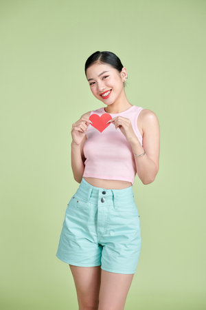 exhilarated woman holding a valentine greeting card in handsの写真素材