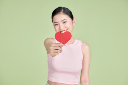 Beautiful woman in love and holding heart shapeの写真素材