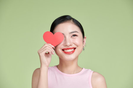 exhilarated woman holding a valentine greeting card in handsの写真素材