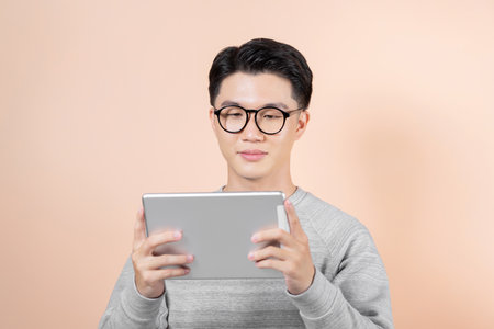 one guy holding and using one grey tabletの写真素材