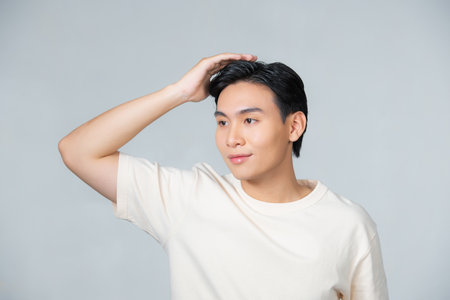 Handsome happy man smiling confident touching hair with hand up gesture,の写真素材