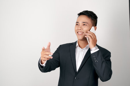 handsome Asian businessman talking mobile phone isolated on studio white background.の写真素材