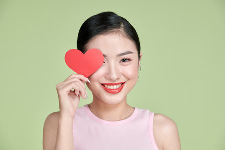 young smile woman hold red heart.の写真素材