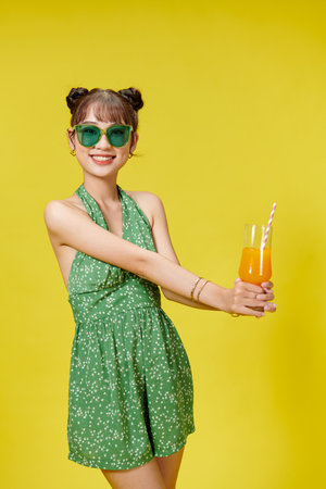 Young beautiful brunette woman on vacation drinking orange juice with happy face smilingの写真素材